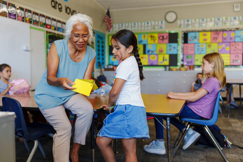 Teacher showing student something.