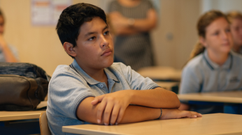 Boy sitting in classroom.