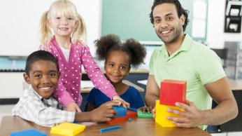 Teacher and students smiling at camera