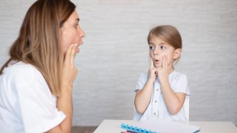 Adult and child practicing oral language