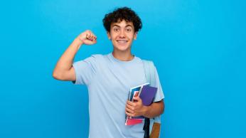 Adolescent reader making a muscle and holding books.