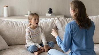 Parent helping child learn oral language.