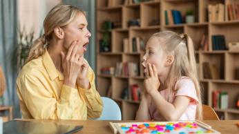 Woman teaching child oral language