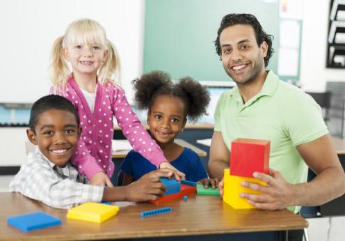 Teacher and students smiling at camera