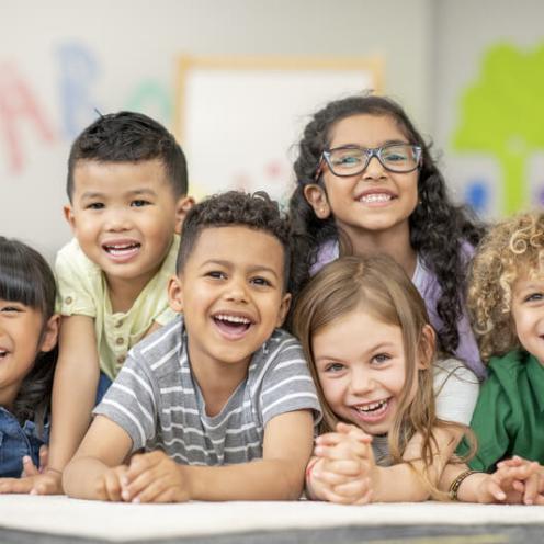 Kids in a group, smiling.