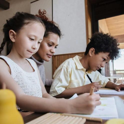 Mother helping children with homework