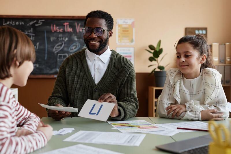 Teacher with two students teaching phonics