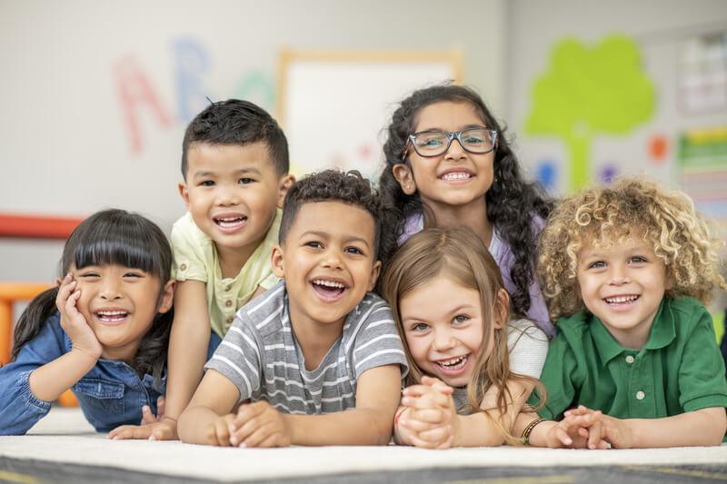 Kids in a group, smiling.