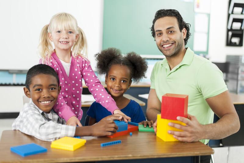 Teacher and students smiling at camera