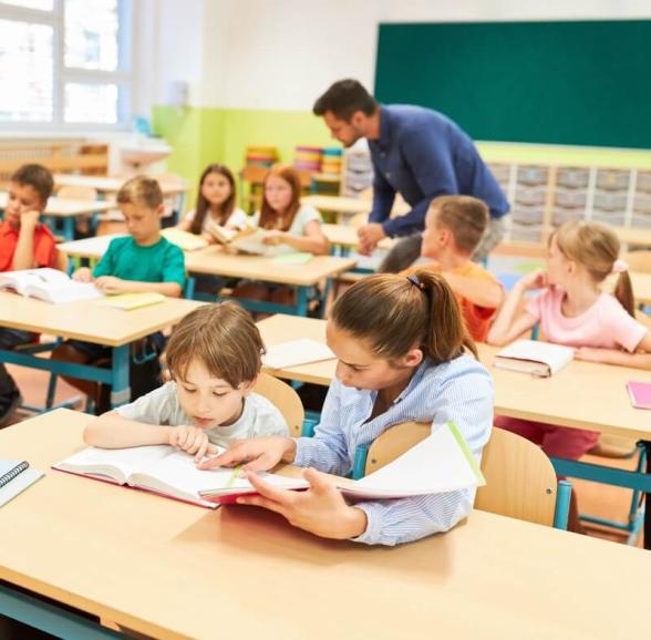 Elementary kids learning to read in a classroom.