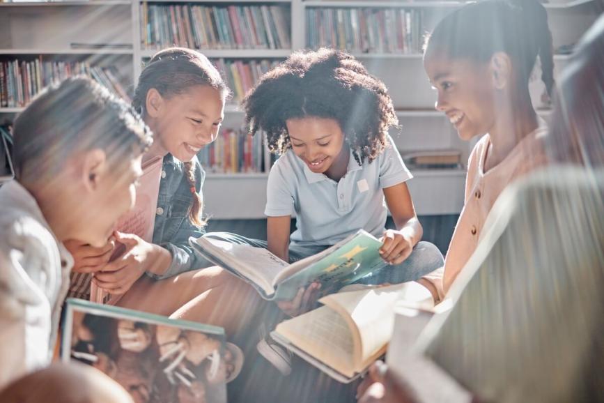 Children reading books in classroom.