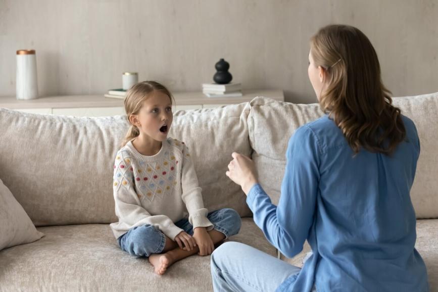 Parent helping child learn oral language.