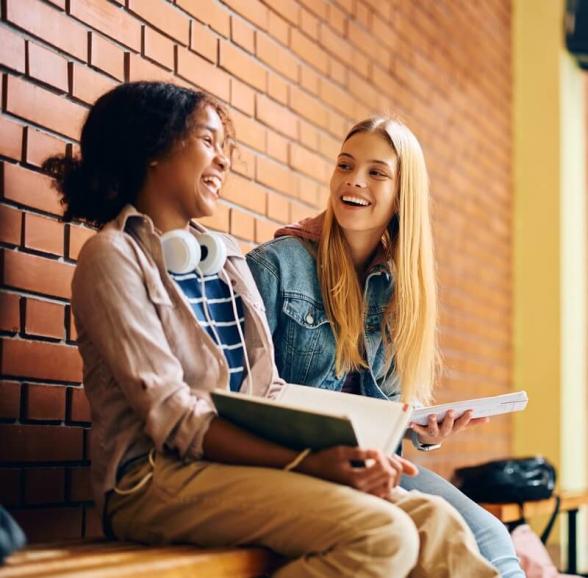 Two students, happily reading together.