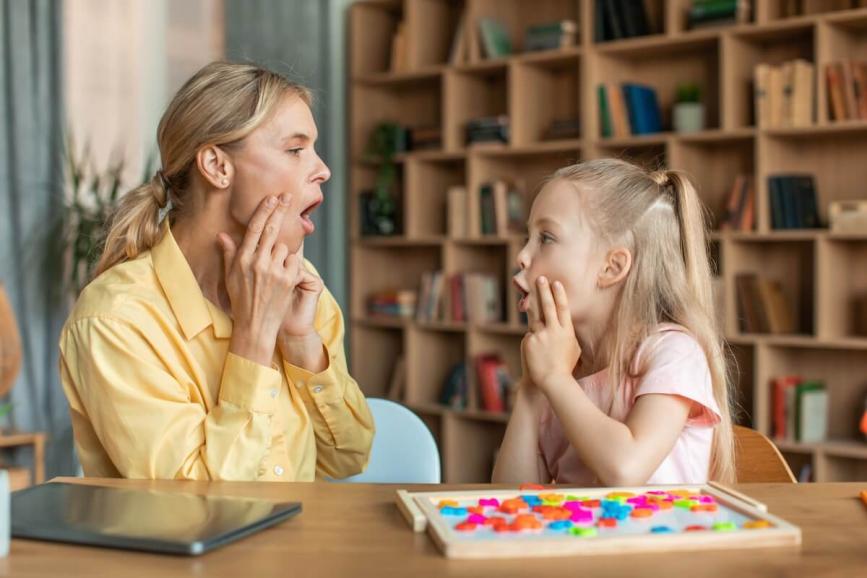 Woman teaching child oral language