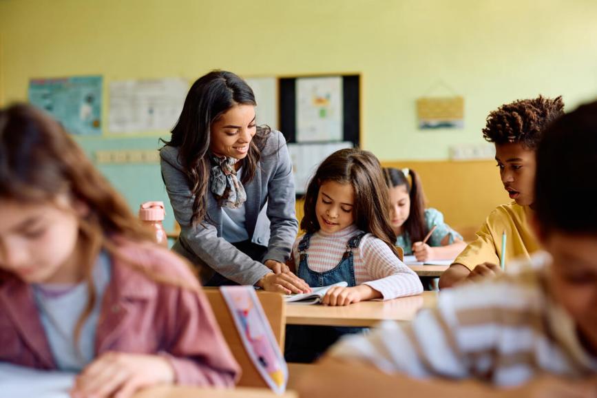 Teacher helping student in class.