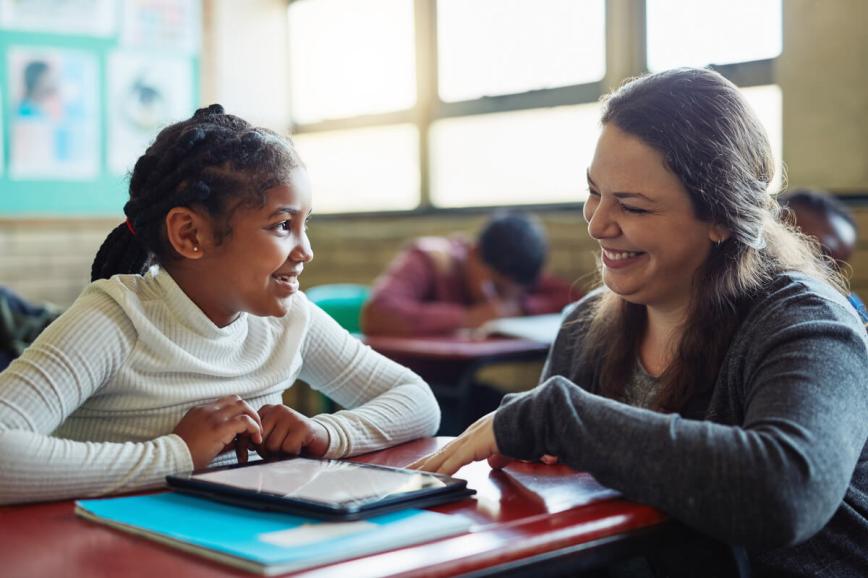 Teacher helping student one on one.