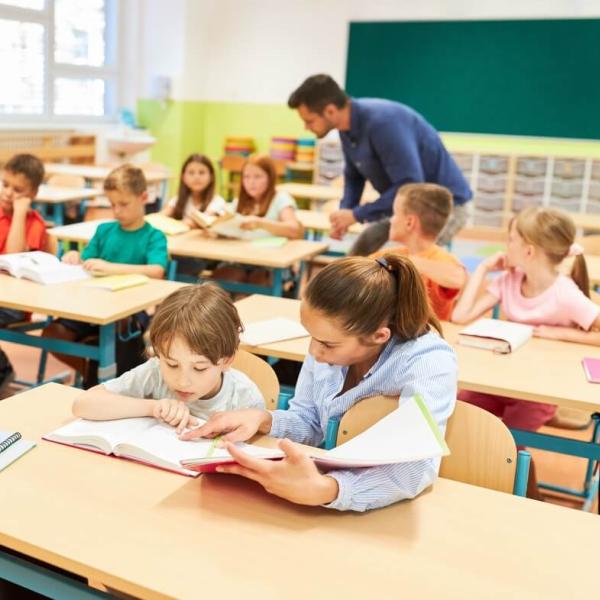 Elementary kids learning to read in a classroom.