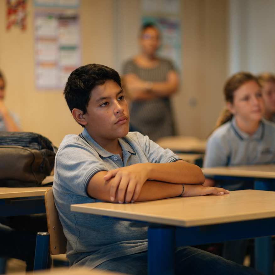 Student in class, attentive to learning.